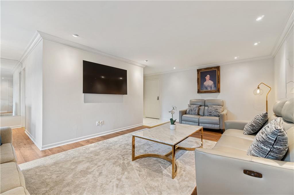 5825 Fifth Avenue, Unit 313 Pittsburgh, PA 15232 - Photo 9 of 24 a living room with furniture and a flat screen tv