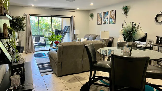 a living room with furniture and a floor to ceiling window