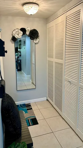 a view of a hallway to a livingroom with furniture