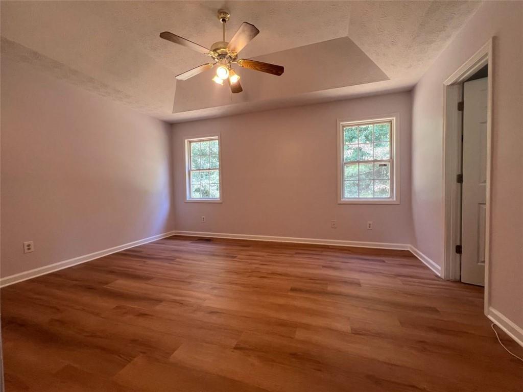 89 Farm Brook Lane Dallas, GA 30157 - Photo 14 of 42 an empty room with wooden floor and windows