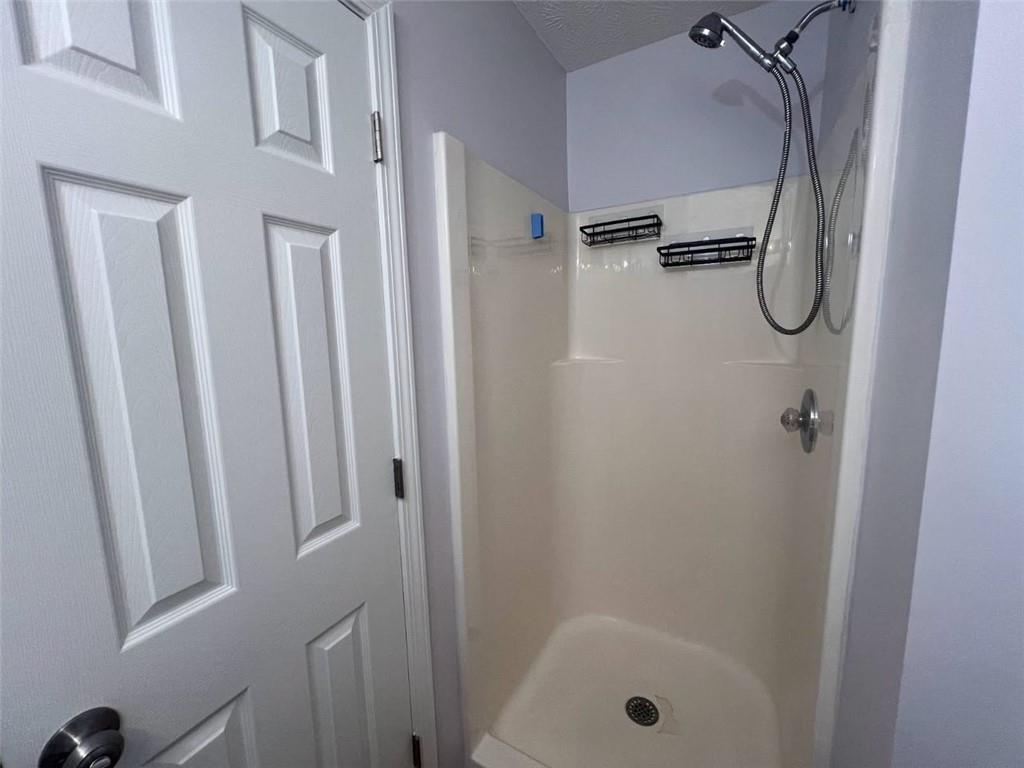 89 Farm Brook Lane Dallas, GA 30157 - Photo 18 of 42 a bathroom with a glass shower door