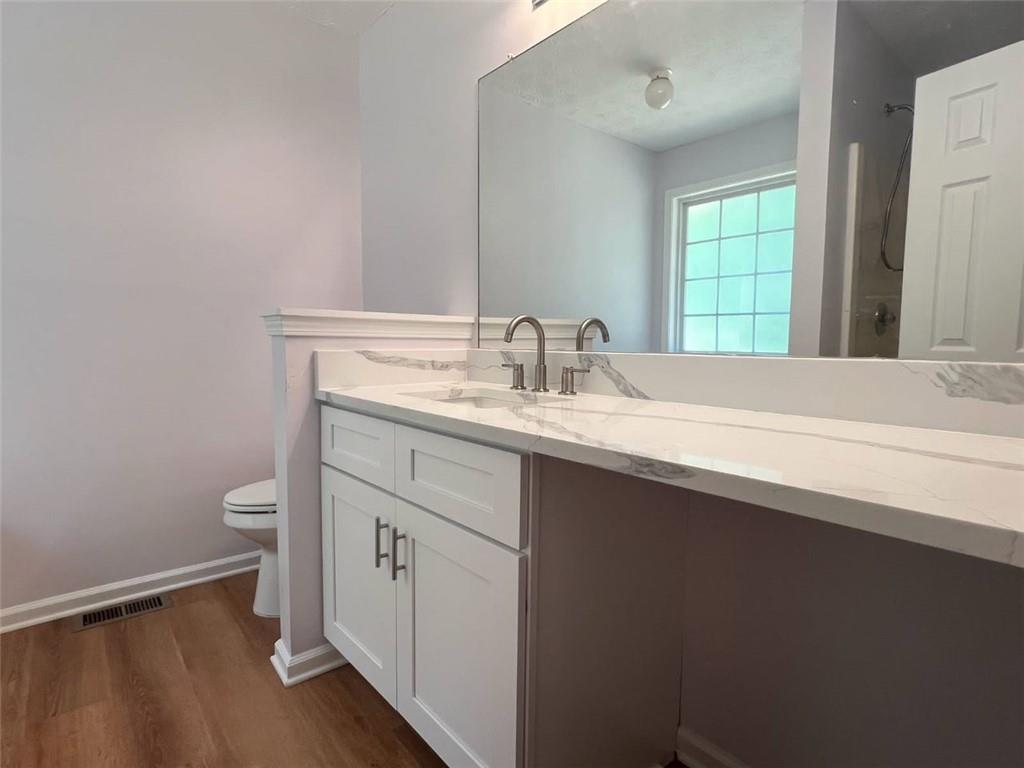 89 Farm Brook Lane Dallas, GA 30157 - Photo 19 of 42 a bathroom with a granite countertop sink toilet and mirror