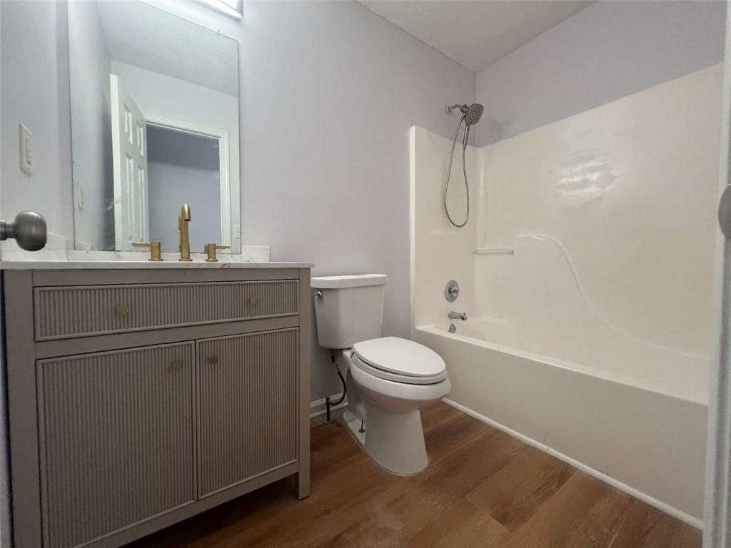 89 Farm Brook Lane Dallas, GA 30157 - Photo 21 of 42 a bathroom with a granite countertop toilet a sink a mirror and shower