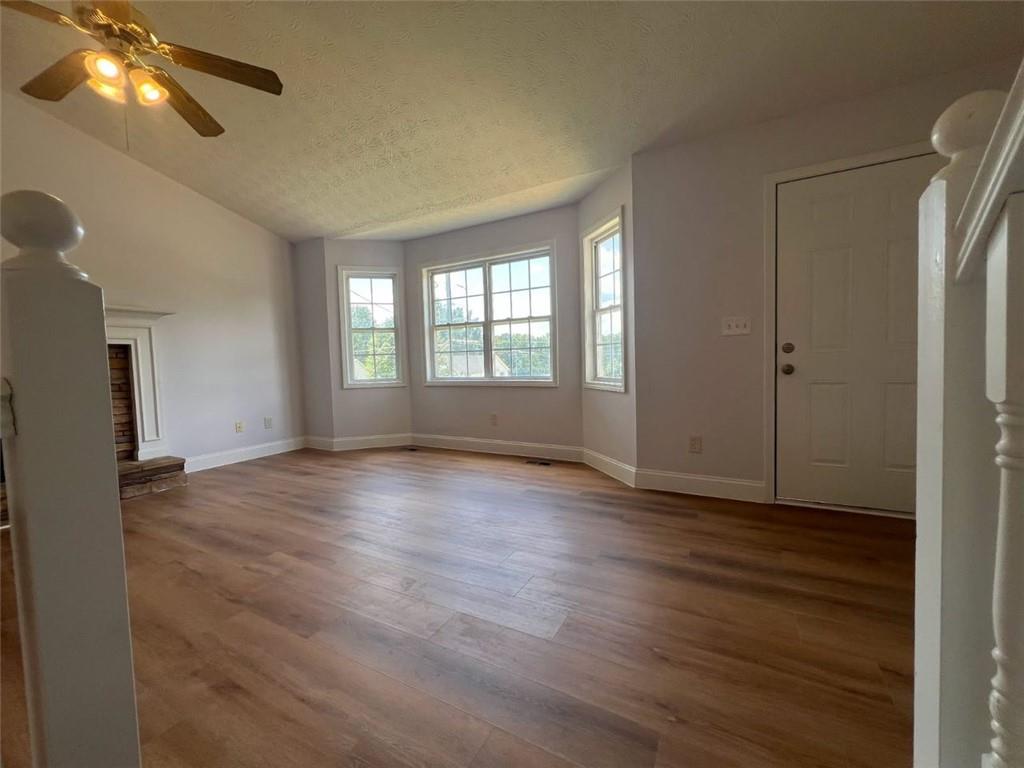 89 Farm Brook Lane Dallas, GA 30157 - Photo 3 of 42 an empty room with wooden floor and windows