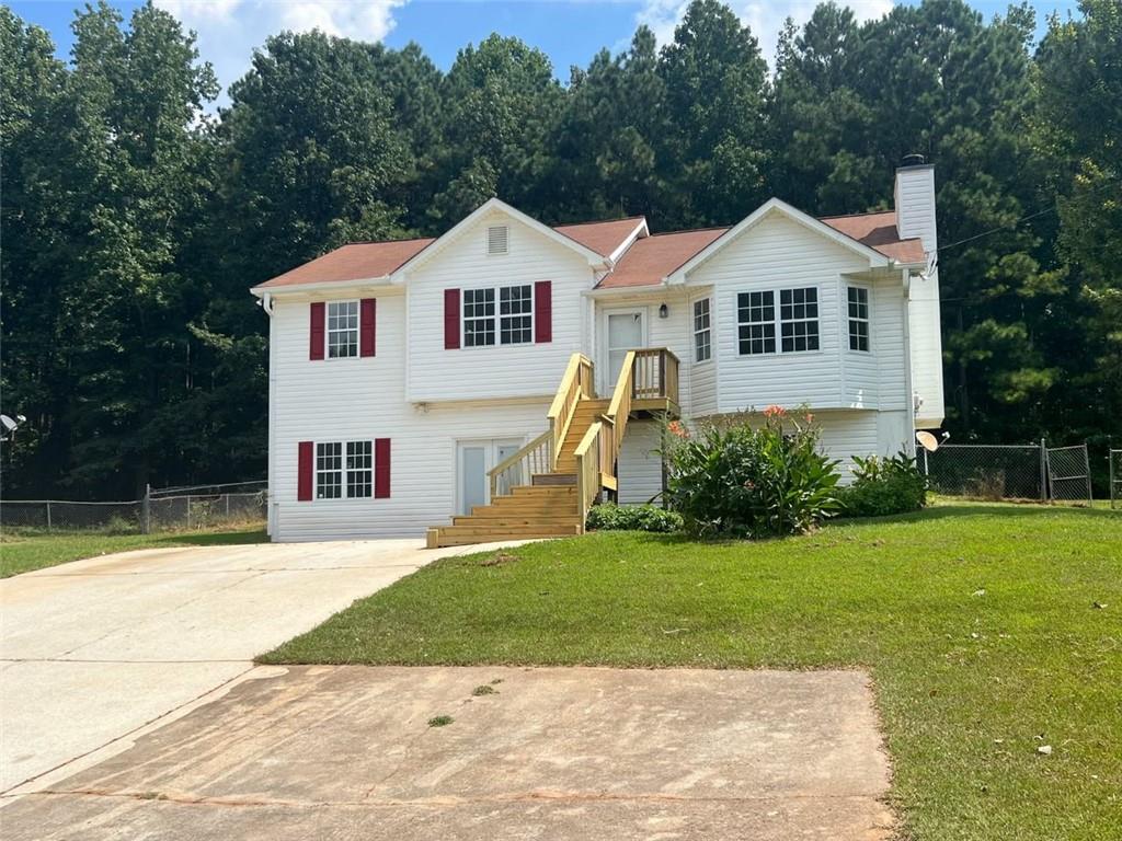 89 Farm Brook Lane Dallas, GA 30157 - Photo 39 of 42 a view of a white house with yard and plants