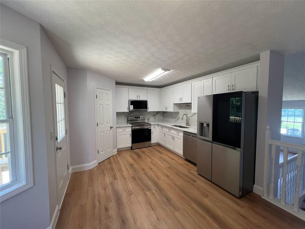 89 Farm Brook Lane Dallas, GA 30157 - Photo 6 of 42 a large kitchen with cabinets and stainless steel appliances