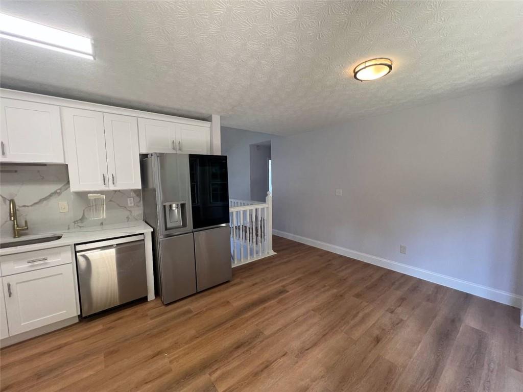 89 Farm Brook Lane Dallas, GA 30157 - Photo 9 of 42 a kitchen with stainless steel appliances a refrigerator sink and microwave