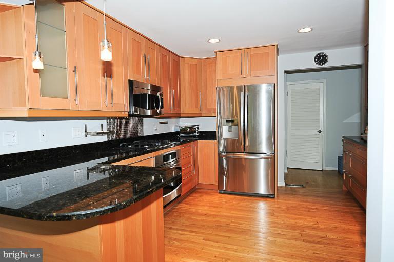 1938 Rockingham Street McLean, VA 22101 - Photo 1 of 4 a kitchen with stainless steel appliances granite countertop a sink stove and refrigerator