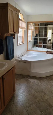 a bathroom with a bathtub a sink and a window