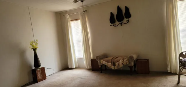 a bedroom with bed and a window