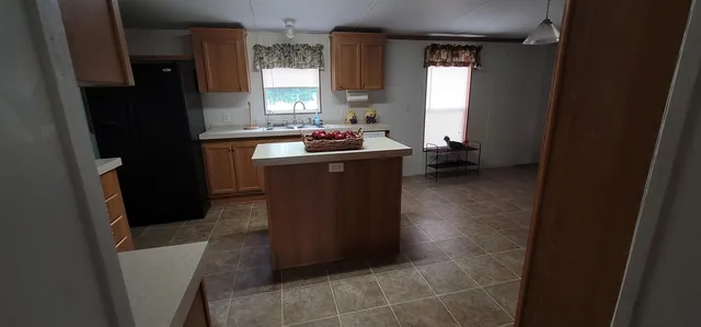 a kitchen with a refrigerator and a sink