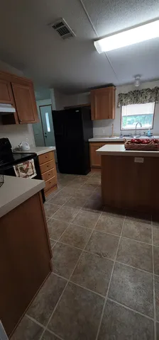 a kitchen with stainless steel appliances a sink a stove a microwave and cabinets