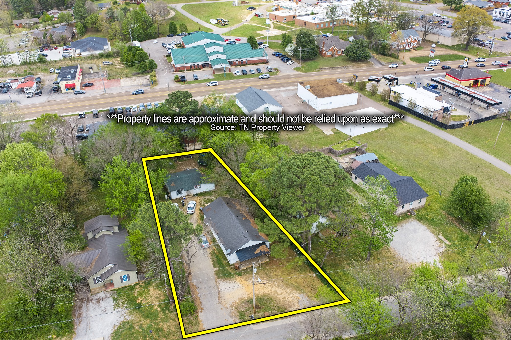 252 North Main Street Lexington, TN 38351 - Photo 3 of 11 an aerial view of residential houses with outdoor space and lake view