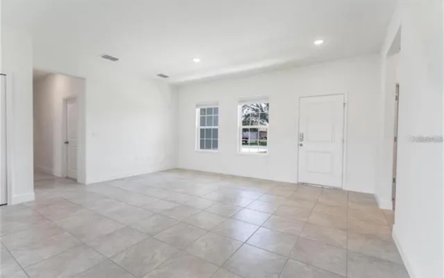 an empty room with windows and closet