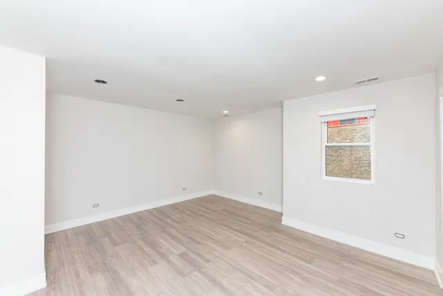 an empty room with wooden floor