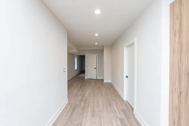 a view of a hallway with wooden floor