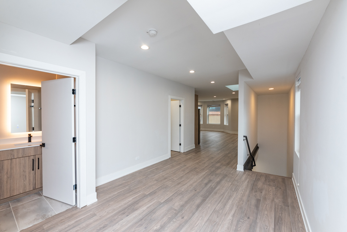1907 South Racine Avenue, Unit 4F Chicago, IL 60608 - Photo 15 of 18 a view of a hallway with wooden floor and a bathroom