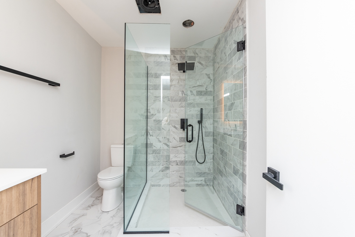 1907 South Racine Avenue, Unit 4F Chicago, IL 60608 - Photo 5 of 18 a bathroom with a granite countertop shower a toilet and a shower