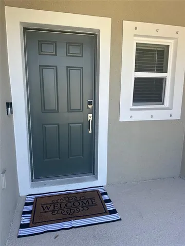 a hallway with a wooden floor and furniture