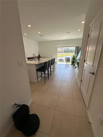 a kitchen with a dining table chairs and white appliances