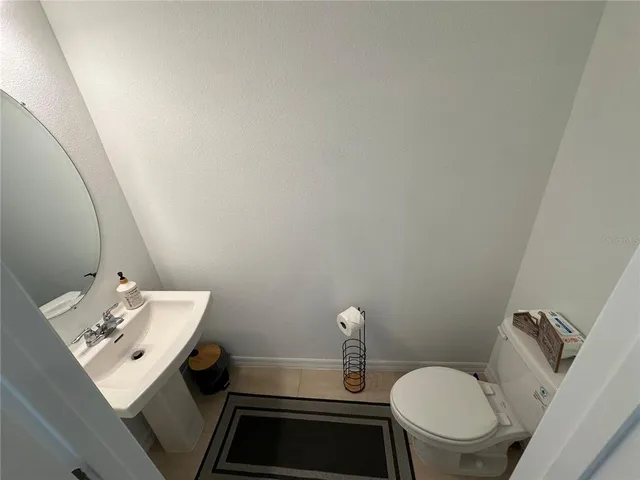 a kitchen with stainless steel appliances a table chairs refrigerator and a sink