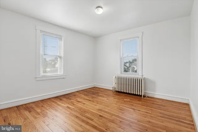 a view of room with wooden floor and window