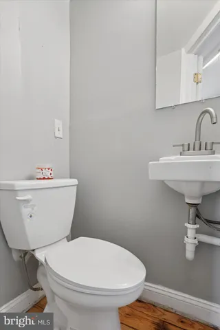 a white toilet sitting next to a bathroom sink