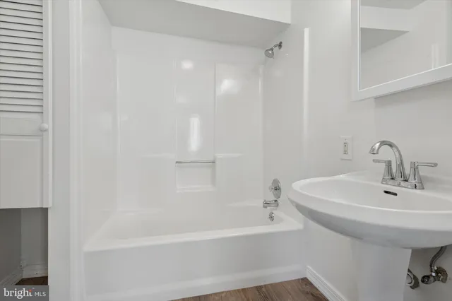 a white bath tub sitting next to a white sink