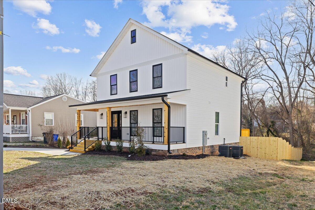 617 North 3rd Street Mebane, NC 27302 - Photo 4 of 50 a view of a white house with large windows next to a road
