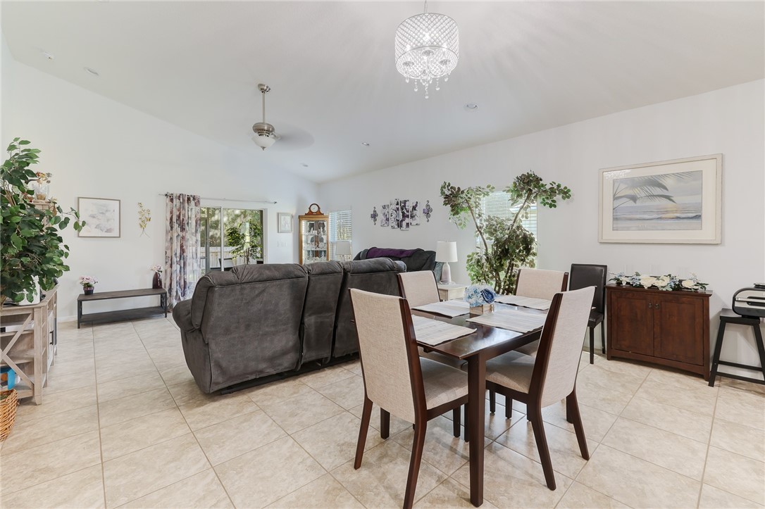 5997 Ridge Lake Circle Vero Beach, FL 32967 - Photo 13 of 36 a view of a dining room with furniture and chandelier