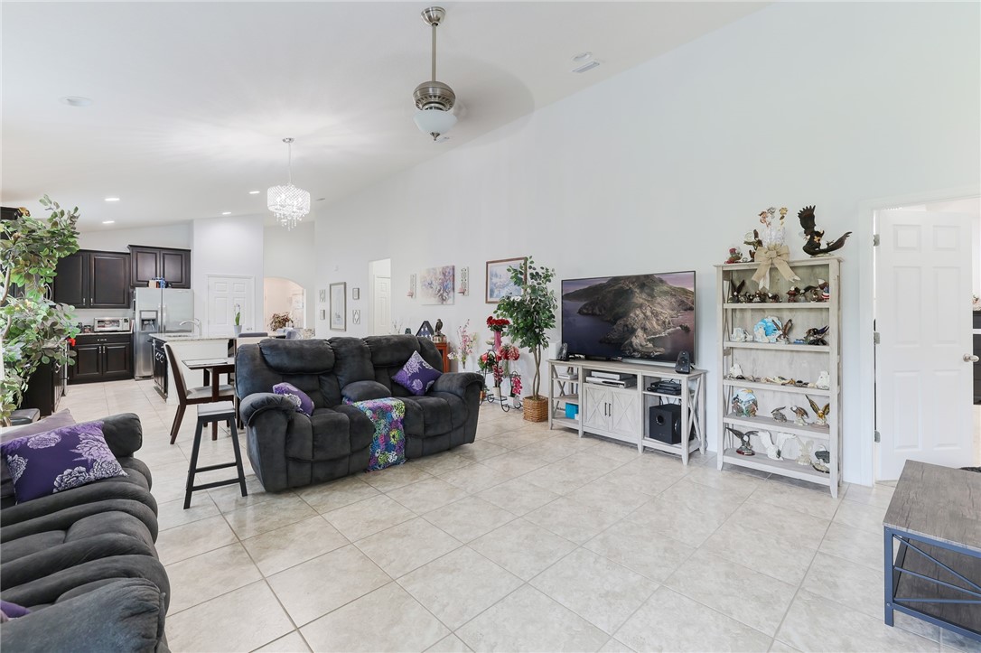 5997 Ridge Lake Circle Vero Beach, FL 32967 - Photo 15 of 36 a living room with furniture and a flat screen tv