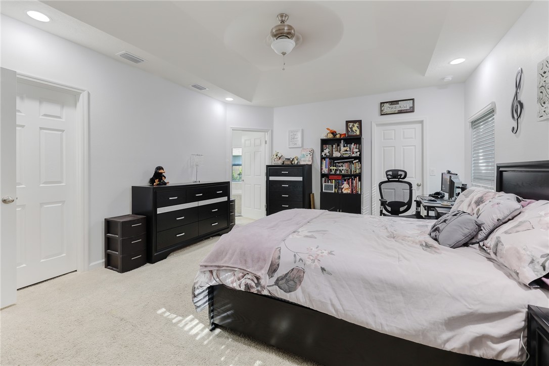 5997 Ridge Lake Circle Vero Beach, FL 32967 - Photo 17 of 36 a bedroom with a bed and dresser