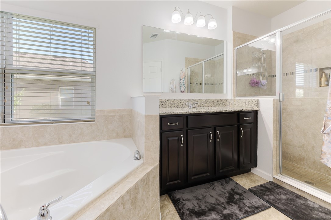 5997 Ridge Lake Circle Vero Beach, FL 32967 - Photo 19 of 36 a bathroom with a bathtub and a sink