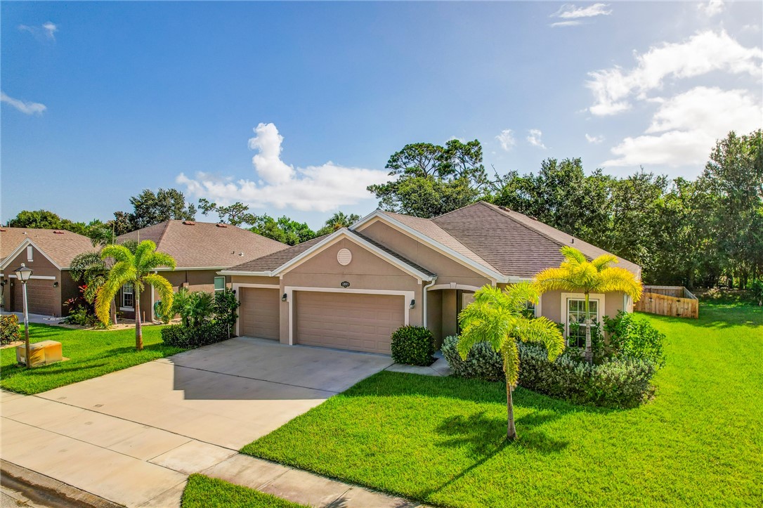 5997 Ridge Lake Circle Vero Beach, FL 32967 - Photo 2 of 36 a front view of a house with garden