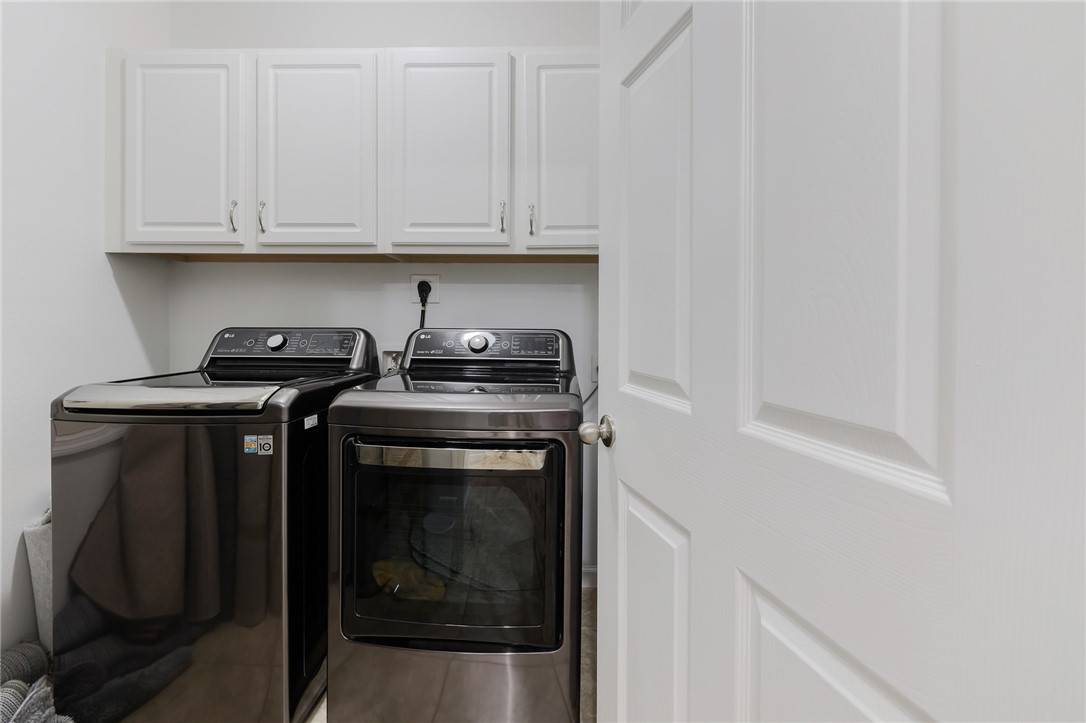 5997 Ridge Lake Circle Vero Beach, FL 32967 - Photo 21 of 36 a utility room with dryer and washer