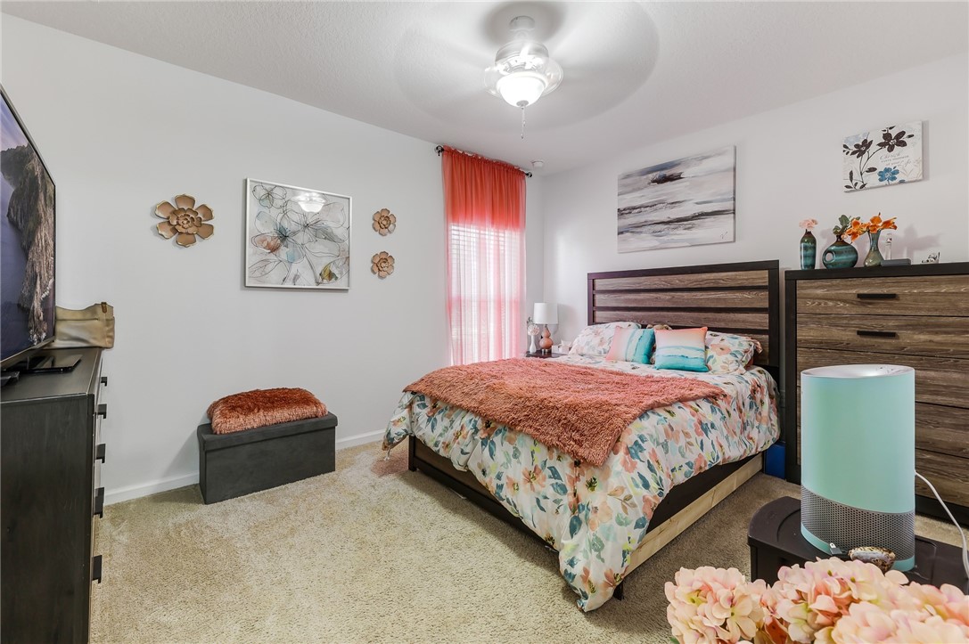 5997 Ridge Lake Circle Vero Beach, FL 32967 - Photo 25 of 36 a bedroom with a bed and window