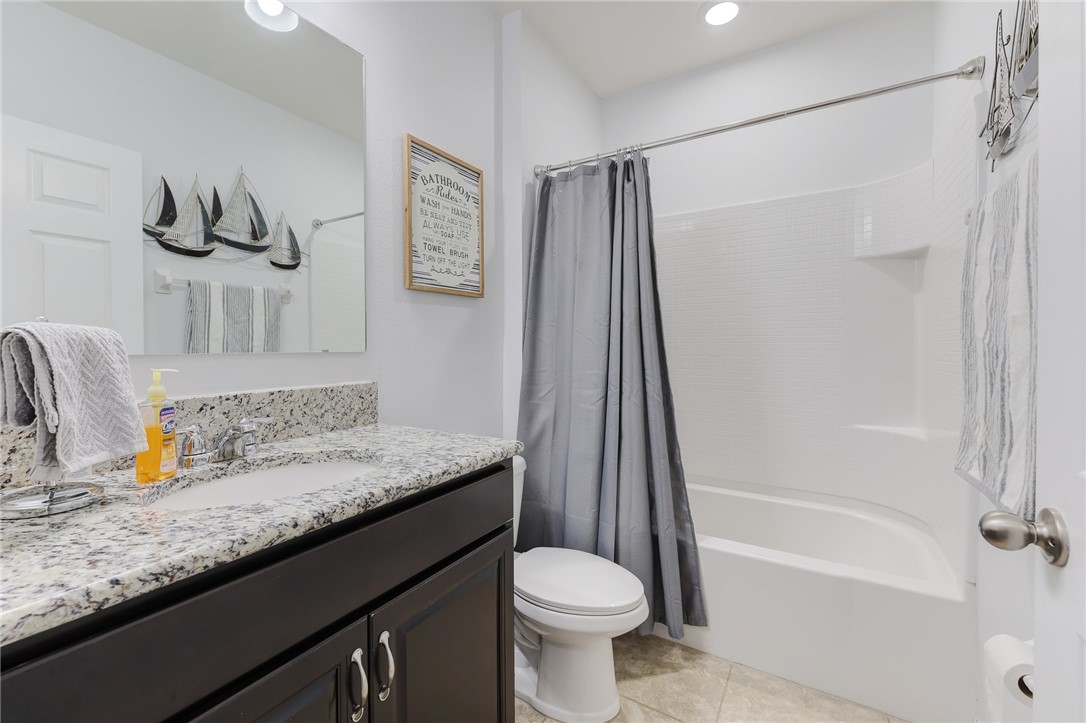 5997 Ridge Lake Circle Vero Beach, FL 32967 - Photo 28 of 36 a bathroom with a granite countertop sink toilet and shower