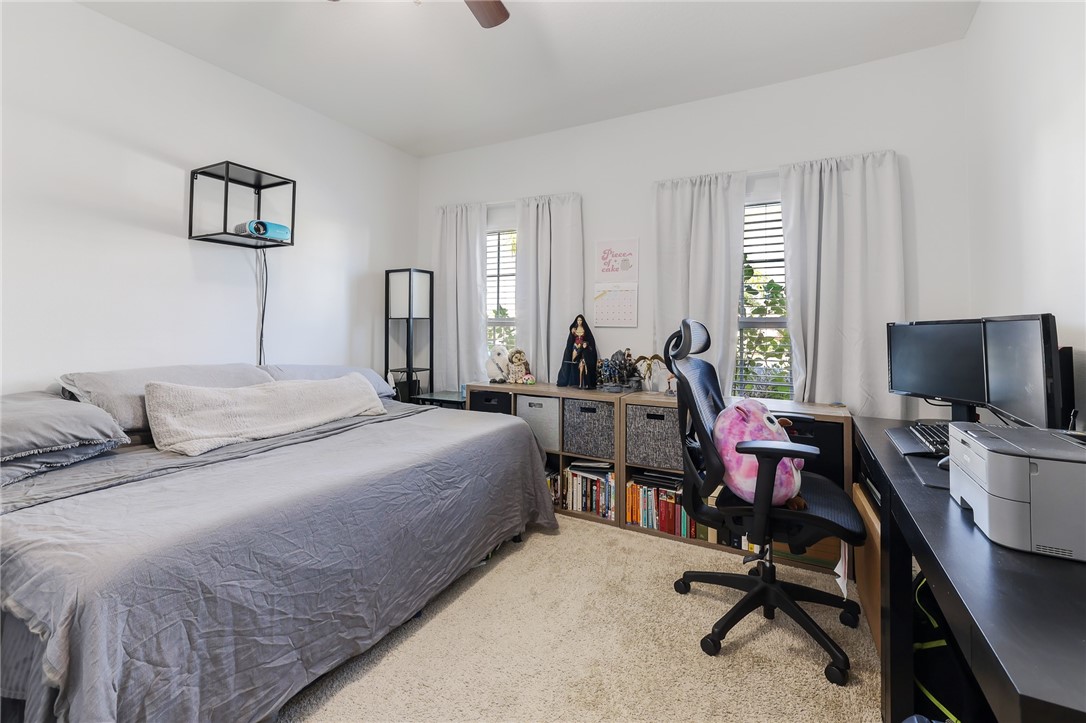 5997 Ridge Lake Circle Vero Beach, FL 32967 - Photo 29 of 36 a bedroom with a bed a desk and chair