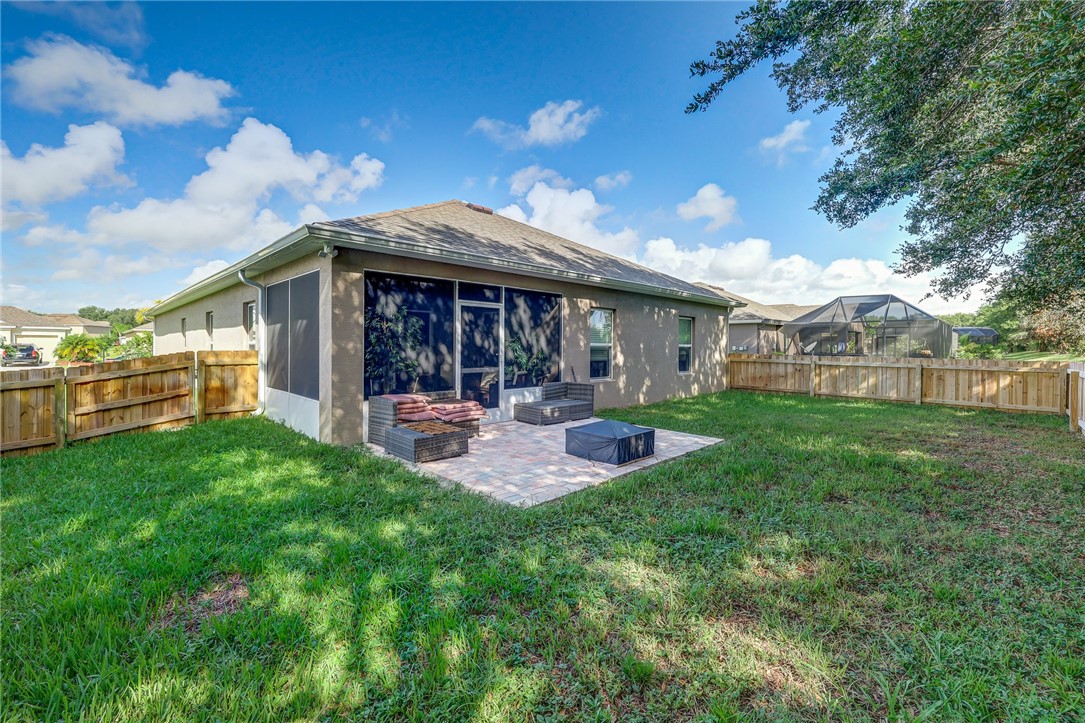 5997 Ridge Lake Circle Vero Beach, FL 32967 - Photo 33 of 36 a view of a house with backyard porch and garden