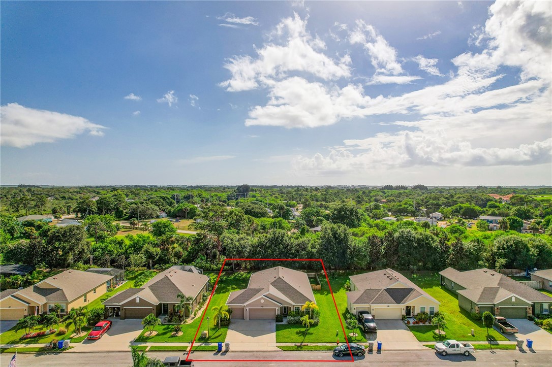 5997 Ridge Lake Circle Vero Beach, FL 32967 - Photo 34 of 36 a view of multiple houses with a yard