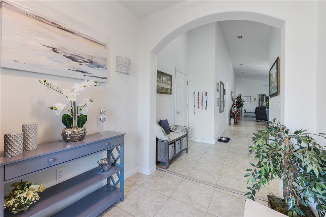 5997 Ridge Lake Circle Vero Beach, FL 32967 - Photo 6 of 36 a living room with furniture and flowers