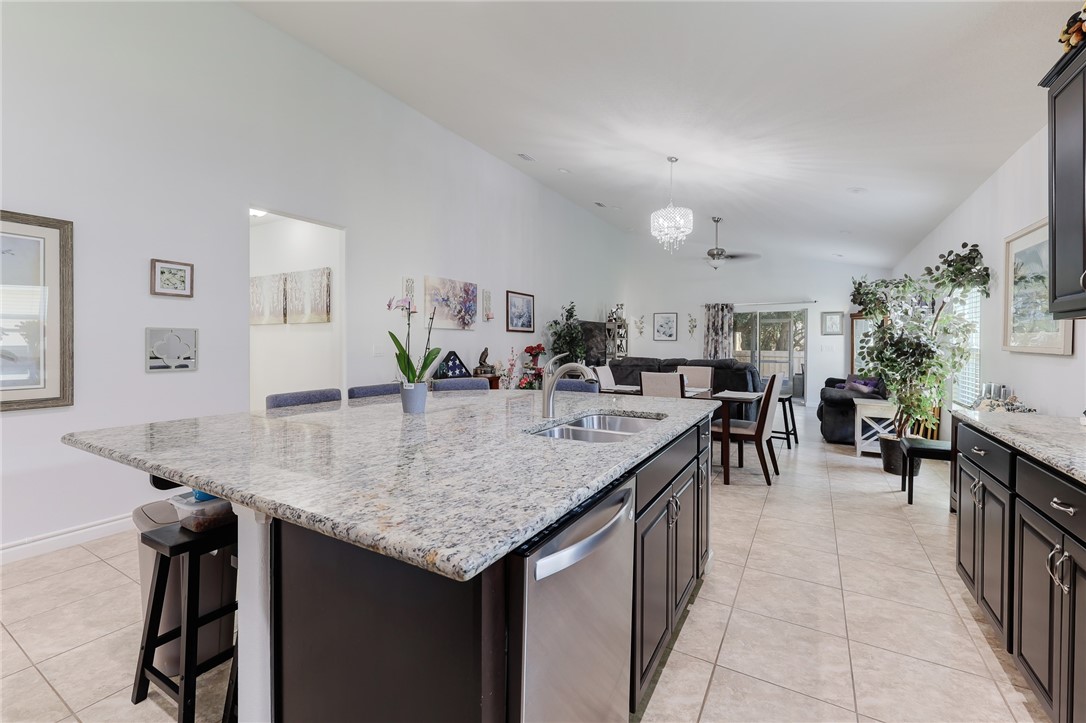 5997 Ridge Lake Circle Vero Beach, FL 32967 - Photo 9 of 36 a kitchen with counter top space and living room