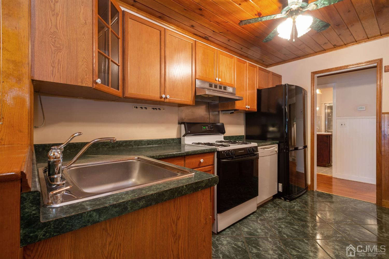 38 Greenbrook Road Middlesex, NJ 08846 - Photo 8 of 18 a kitchen with stainless steel appliances granite countertop a sink a stove and a refrigerator