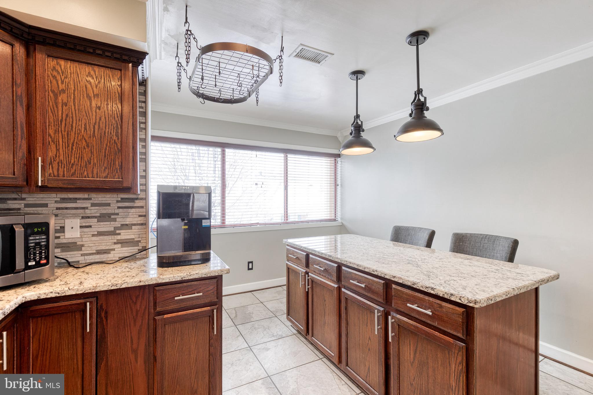 8008 Valley Manor Road, Unit 3B Owings Mills, MD 21117 - Photo 11 of 19 a kitchen with stainless steel appliances granite countertop a sink and a window