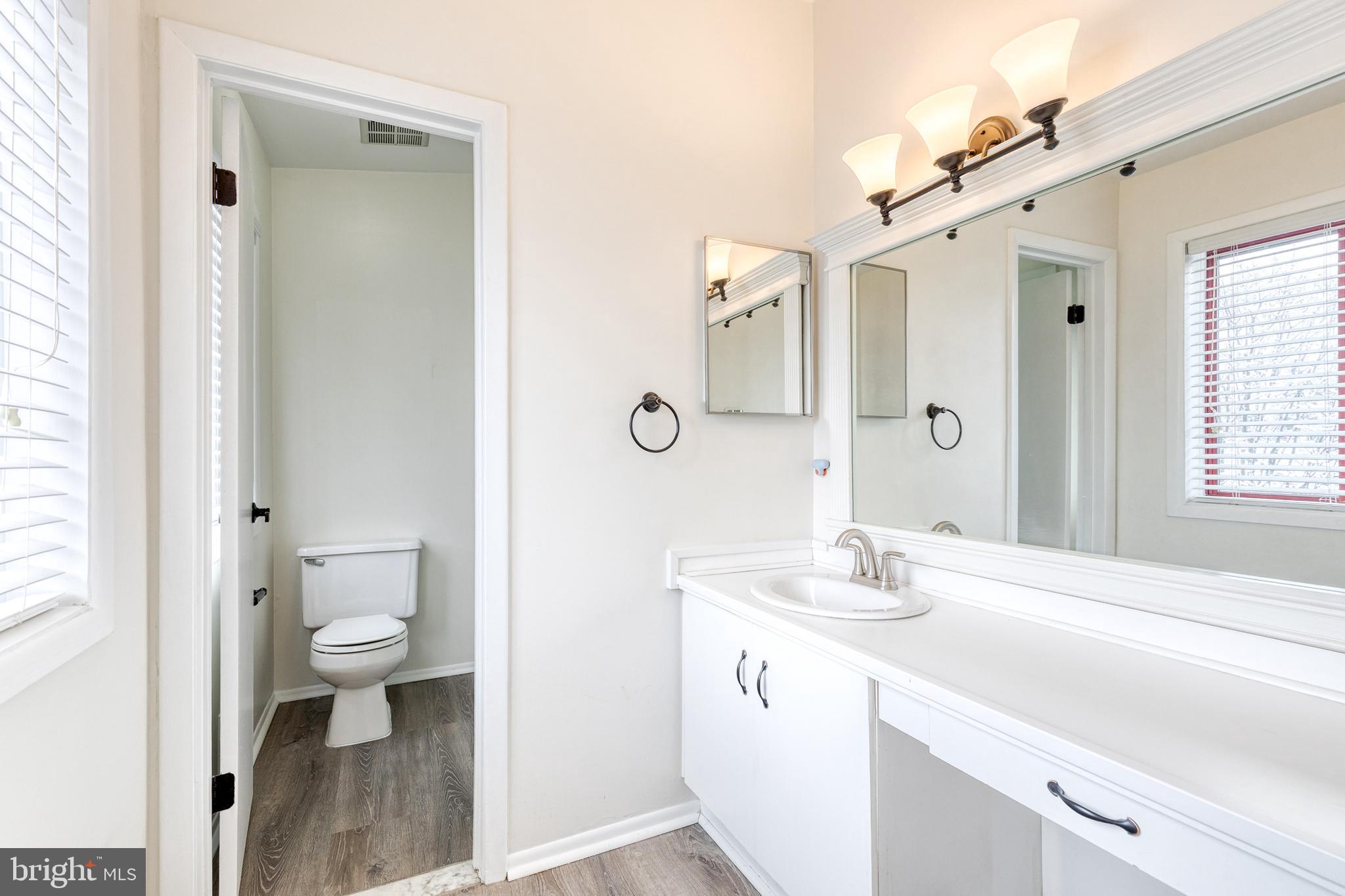 8008 Valley Manor Road, Unit 3B Owings Mills, MD 21117 - Photo 14 of 19 a bathroom with a sink a toilet and shower