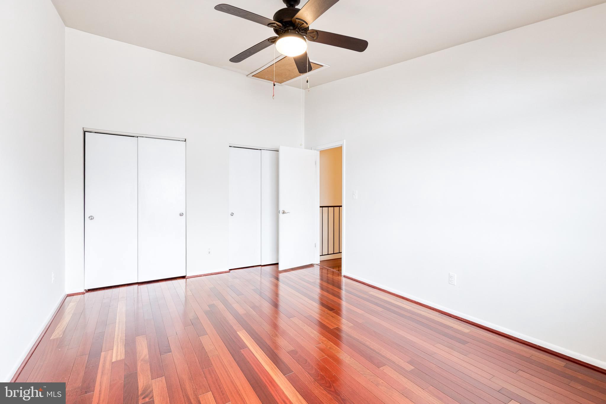8008 Valley Manor Road, Unit 3B Owings Mills, MD 21117 - Photo 17 of 19 a view of an empty room with wooden floor