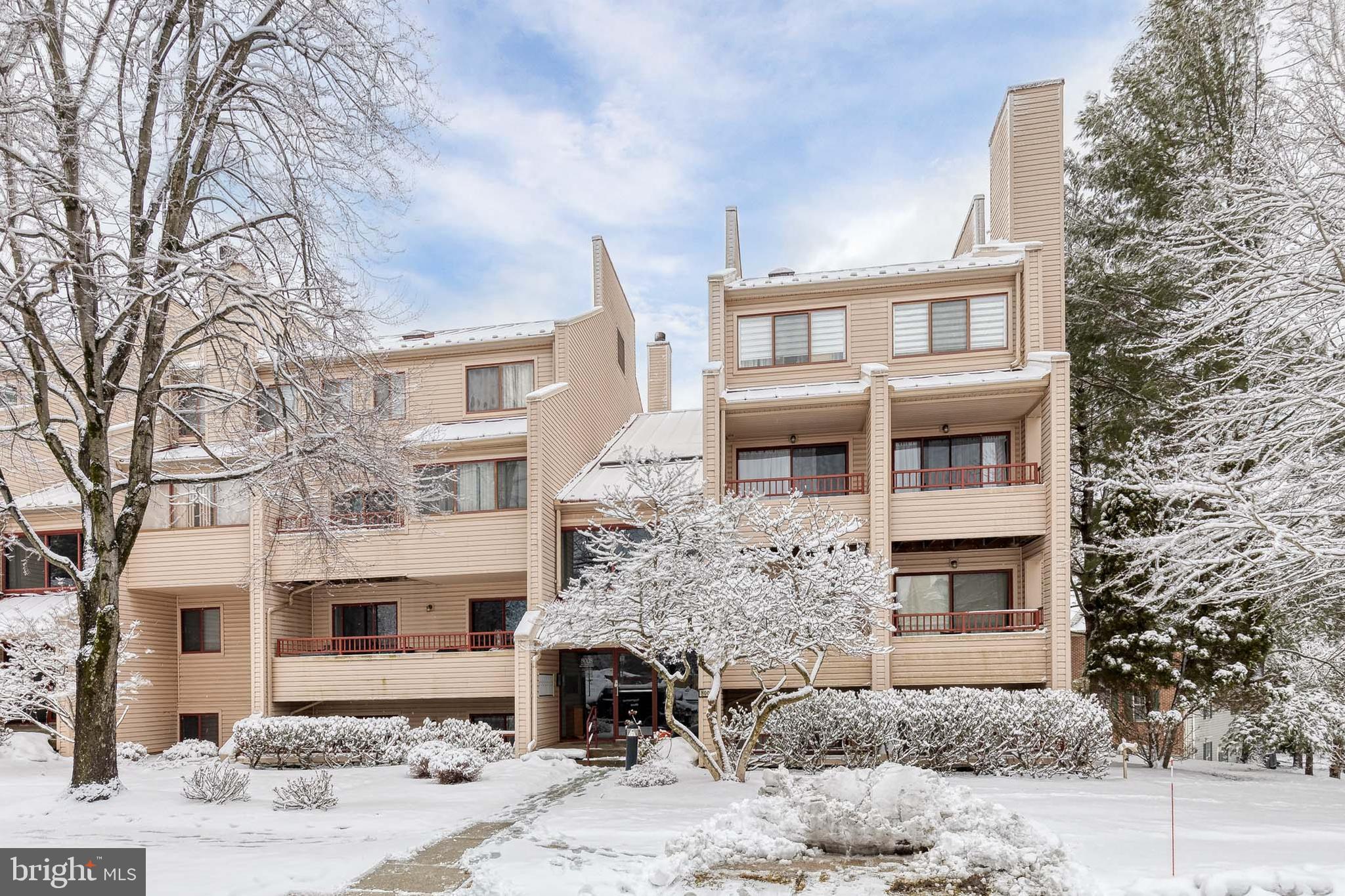 8008 Valley Manor Road, Unit 3B Owings Mills, MD 21117 - Photo 2 of 19 a front view of a building with yard