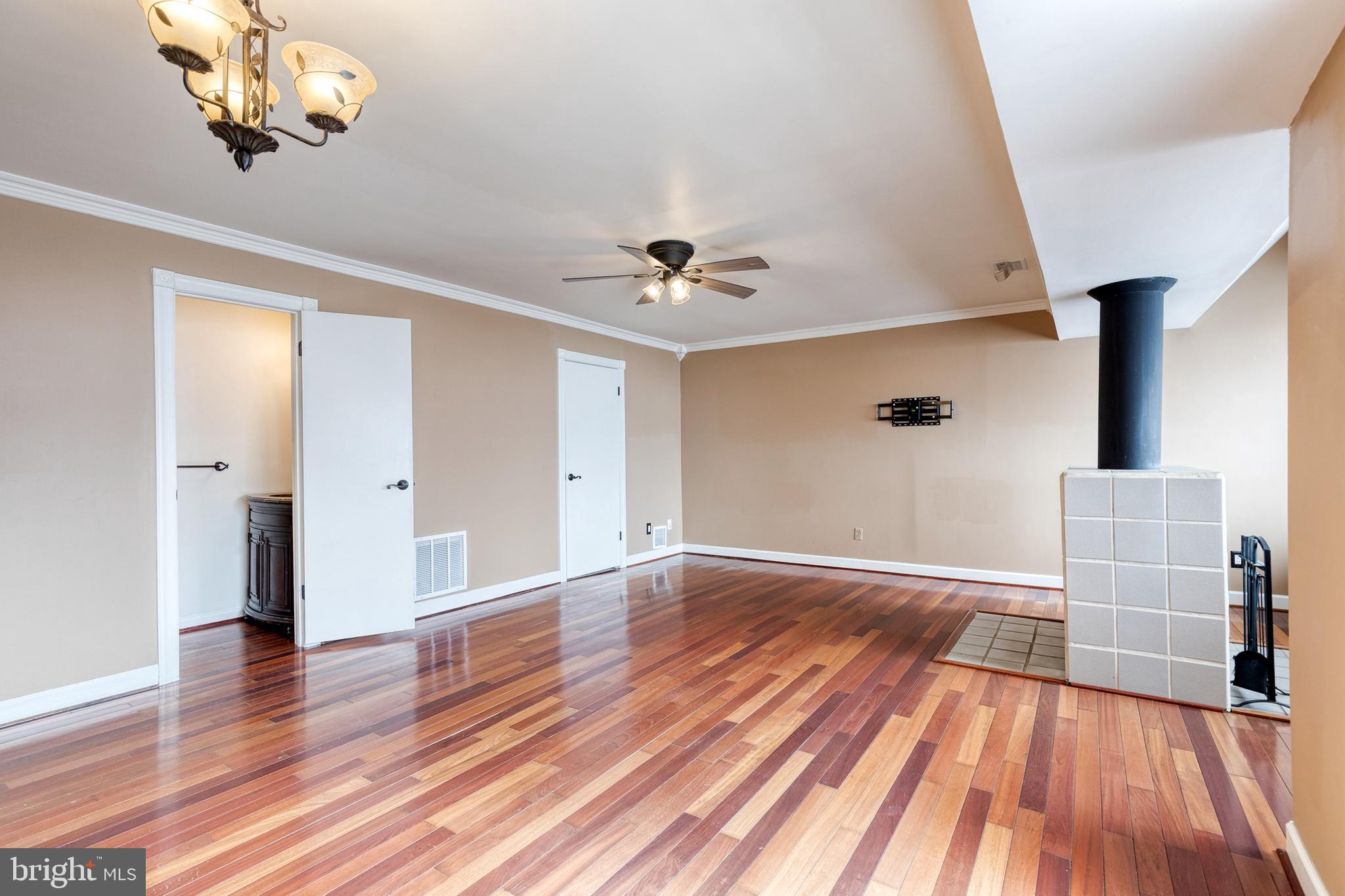 8008 Valley Manor Road, Unit 3B Owings Mills, MD 21117 - Photo 4 of 19 wooden floor in an empty room with a window