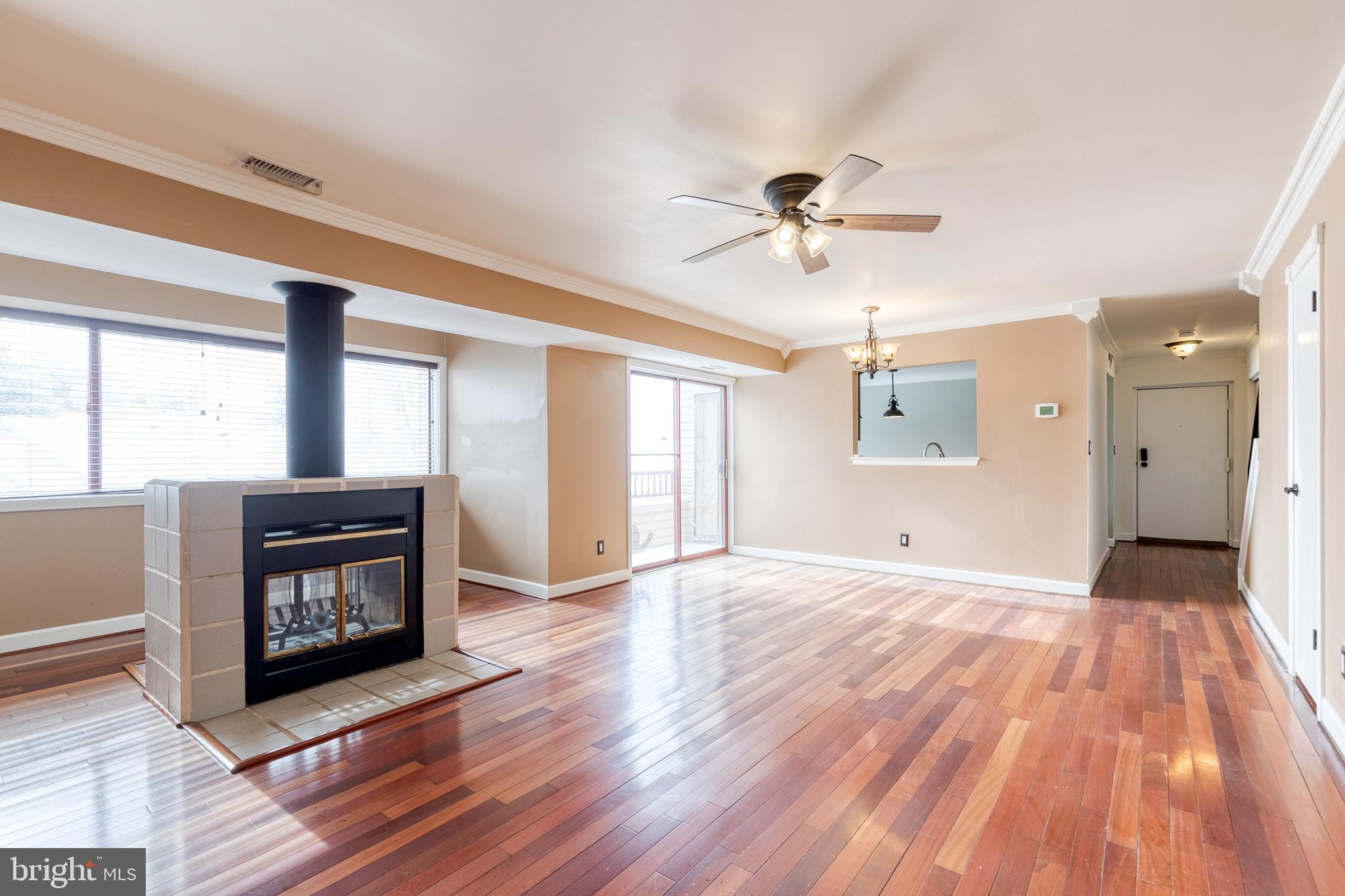 8008 Valley Manor Road, Unit 3B Owings Mills, MD 21117 - Photo 5 of 19 a view of an empty room with a window and wooden floor