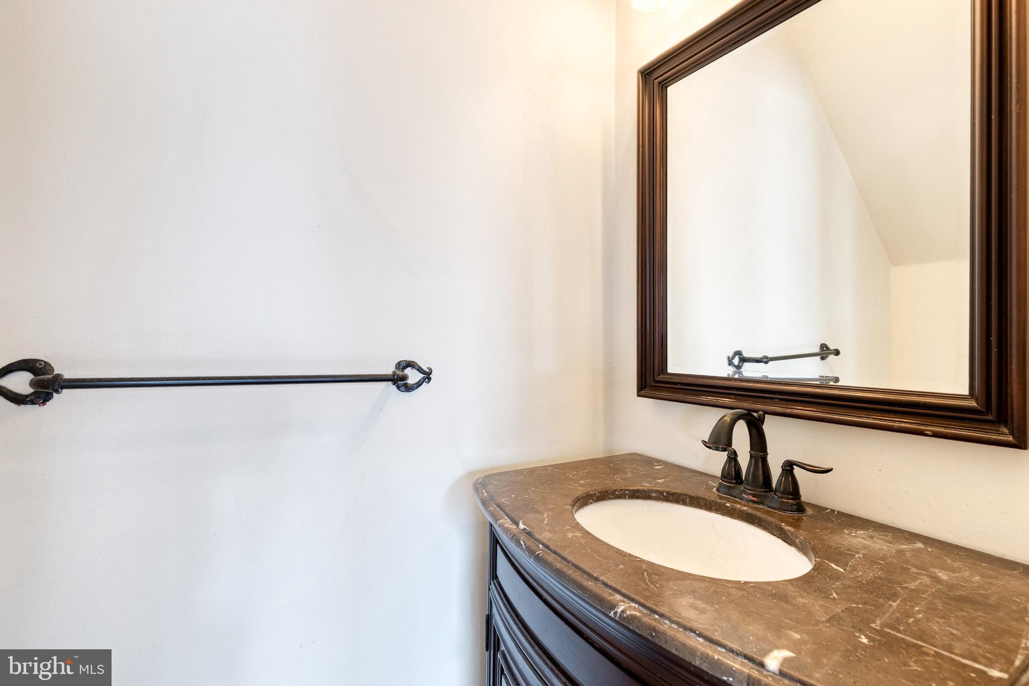 8008 Valley Manor Road, Unit 3B Owings Mills, MD 21117 - Photo 6 of 19 a bathroom with a granite countertop sink and a mirror